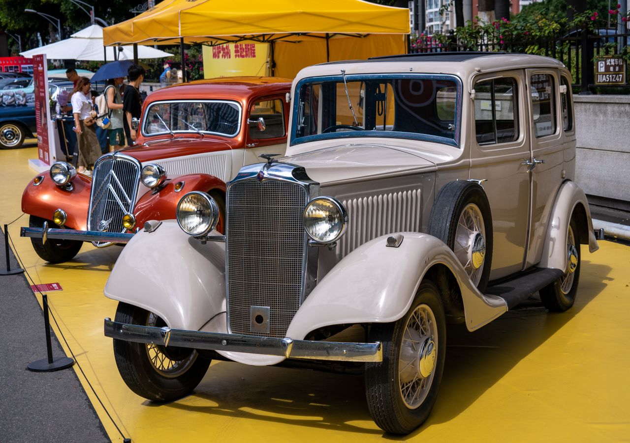 Showcase of classic vintage cars at an outdoor auto exhibition.